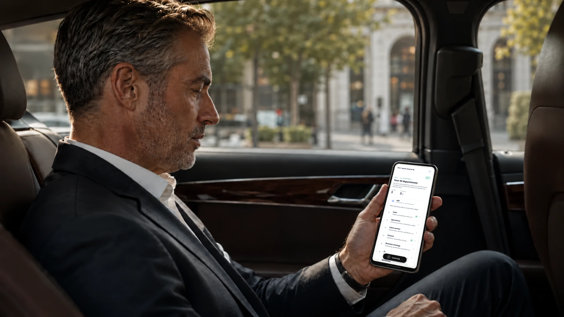 A business owner in the back of a car checks the AI departments directory in Reach Central AI on his phone.